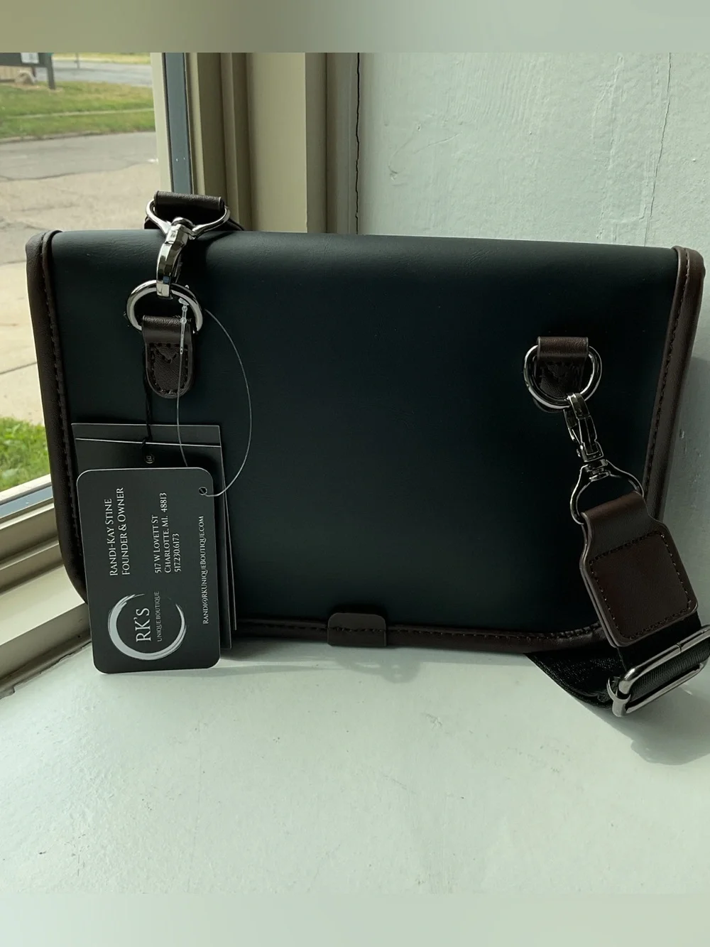 Black Crossbody Bag with Brown Trim and Adjustable Strap